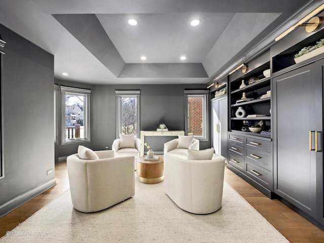 sitting room with baseboards, recessed lighting, and a raised ceiling