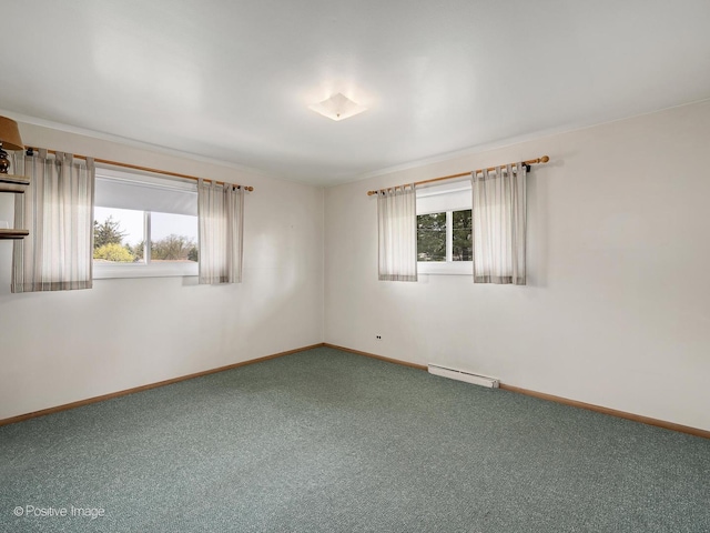 empty room featuring baseboards, plenty of natural light, carpet, and a baseboard heating unit