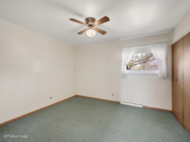 carpeted spare room with ceiling fan, a baseboard heating unit, and baseboards