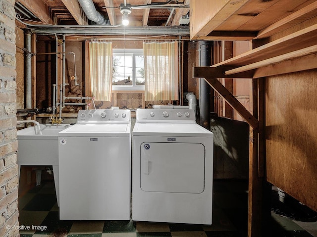 laundry room featuring a sink, separate washer and dryer, laundry area, and tile patterned floors
