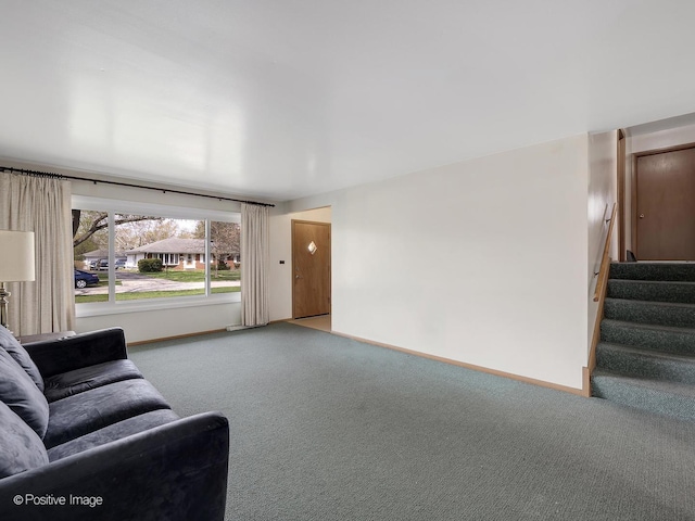 living area with carpet floors, baseboards, and stairway