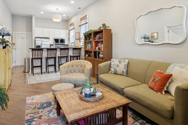living area with wood finished floors and recessed lighting