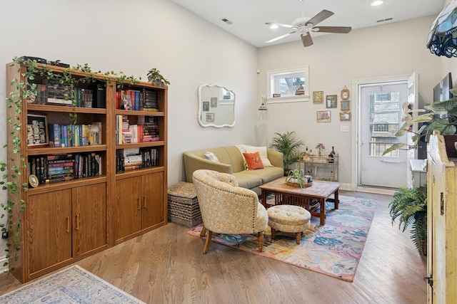 living area featuring a ceiling fan, wood finished floors, and recessed lighting