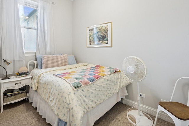 bedroom with carpet flooring and baseboards