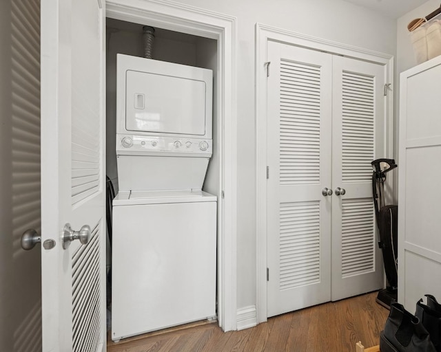 laundry area featuring stacked washer / dryer