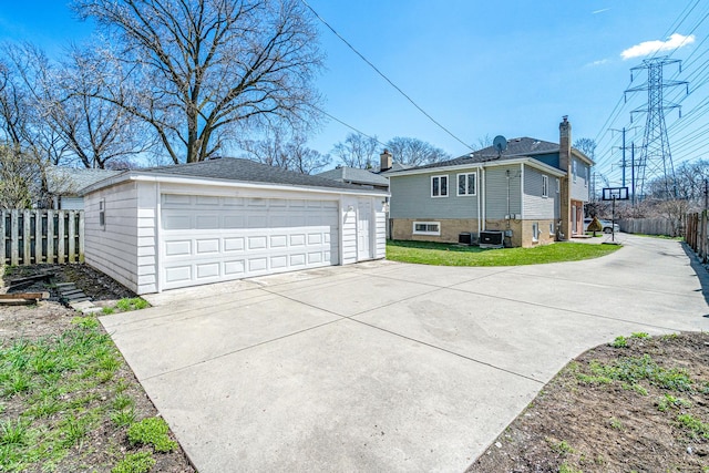48 Hackberry Ln, Glenview, IL 60025 - view of side of home with fence, central air condition unit, an outdoor structure, a lawn, and a garage