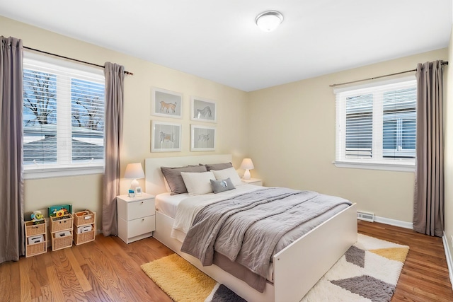 48 Hackberry Ln, Glenview, IL 60025 - bedroom with multiple windows, visible vents, and light wood-style flooring