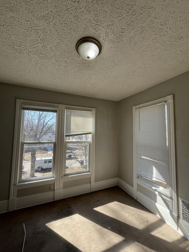 506 E Chestnut St, Bloomington, IL 61701 - empty room featuring baseboards, carpet flooring, and a textured ceiling