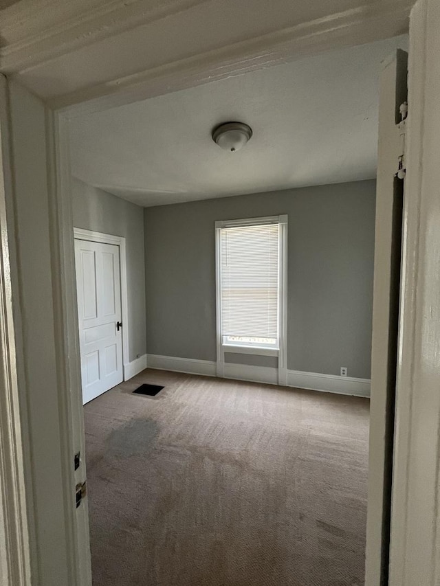 506 E Chestnut St, Bloomington, IL 61701 - empty room with baseboards and carpet floors