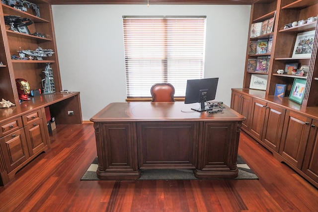 office area with dark wood-style flooring and built in shelves