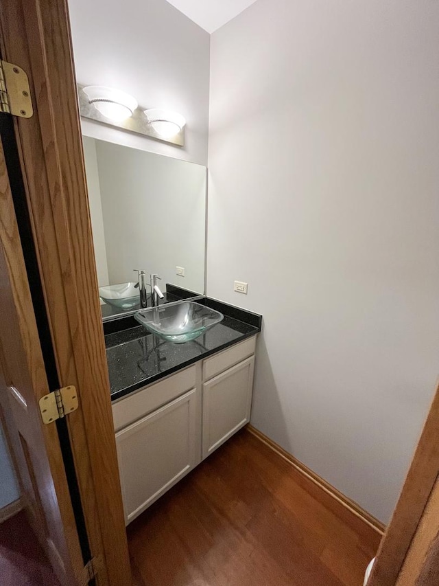 bathroom with vanity and wood finished floors