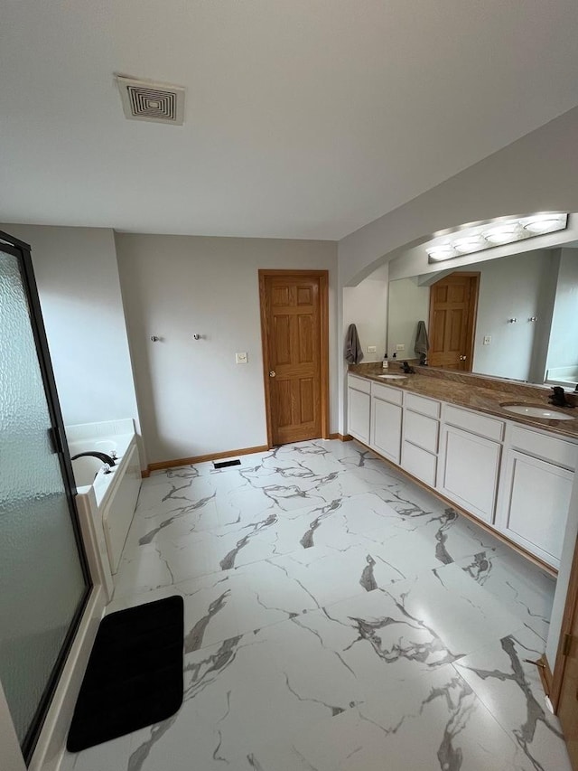 bathroom featuring double vanity, visible vents, a sink, baseboards, and marble finish floor