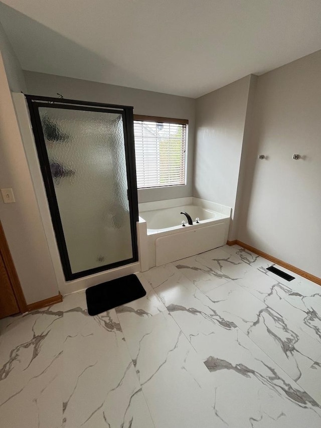 full bathroom with baseboards, a stall shower, marble finish floor, and a bath