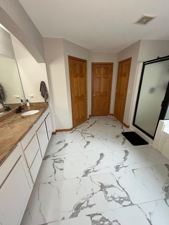bathroom with visible vents, marble finish floor, baseboards, and a shower stall