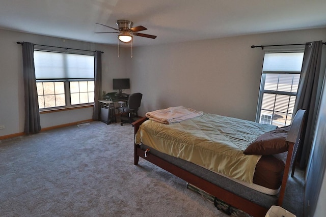 carpeted bedroom featuring baseboards and ceiling fan