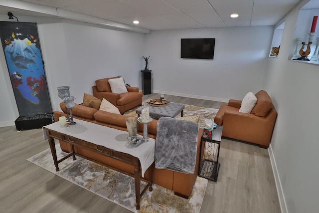 living area with recessed lighting, baseboards, and wood finished floors