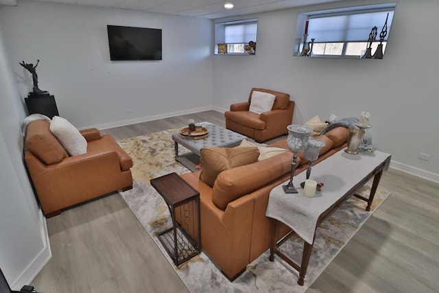 living area featuring baseboards, recessed lighting, and wood finished floors