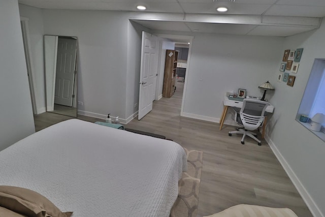 bedroom featuring baseboards, recessed lighting, and wood finished floors