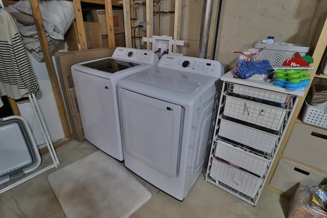 clothes washing area featuring washer and dryer