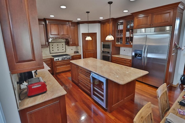 kitchen with built in appliances, beverage cooler, recessed lighting, tasteful backsplash, and a kitchen island
