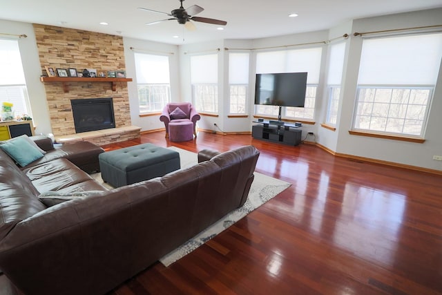 living room with plenty of natural light, a ceiling fan, and wood finished floors