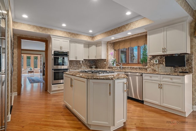 1330 Kurtis Ln, Lake Forest, IL 60045 - kitchen with stainless steel appliances, light wood-type flooring, white cabinetry, a center island, and crown molding