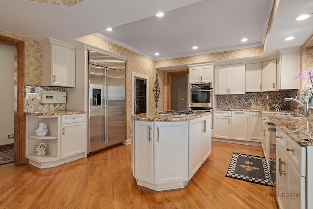 1330 Kurtis Ln, Lake Forest, IL 60045 - kitchen with stainless steel appliances, a sink, white cabinetry, crown molding, and light wood-style flooring