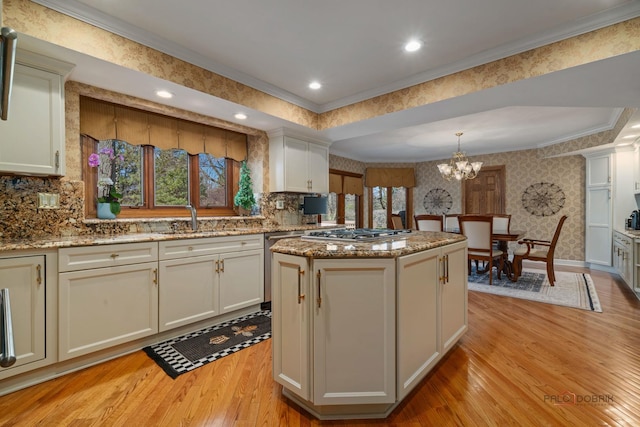 1330 Kurtis Ln, Lake Forest, IL 60045 - kitchen with light wood-style floors, a center island, stainless steel gas stovetop, a sink, and wallpapered walls