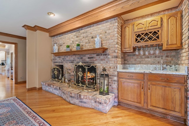 1330 Kurtis Ln, Lake Forest, IL 60045 - indoor wet bar featuring ornamental molding, light wood-type flooring, a brick fireplace, and baseboards