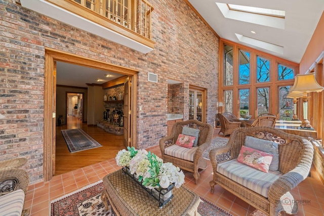 1330 Kurtis Ln, Lake Forest, IL 60045 - living area featuring tile patterned flooring, a skylight, a towering ceiling, and brick wall