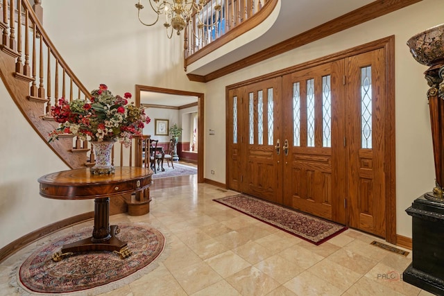 1330 Kurtis Ln, Lake Forest, IL 60045 - foyer entrance with healthy amount of natural light, baseboards, a high ceiling, a chandelier, and crown molding