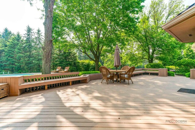 1330 Kurtis Ln, Lake Forest, IL 60045 - deck featuring an outdoor pool, outdoor dining space, and view of wooded area