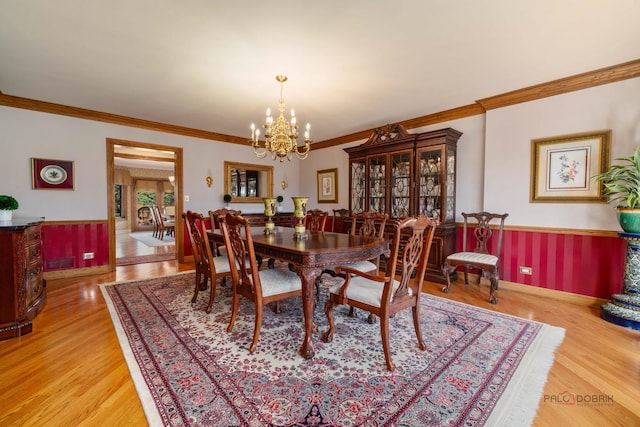 1330 Kurtis Ln, Lake Forest, IL 60045 - dining room with crown molding, a chandelier, light wood finished floors, a wainscoted wall, and baseboards