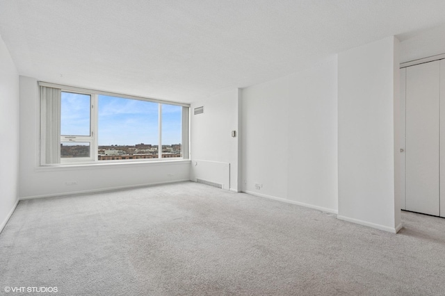 living room featuring light carpet and baseboards