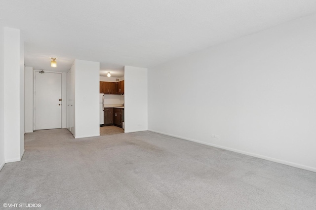 bedroom featuring light colored carpet and baseboards
