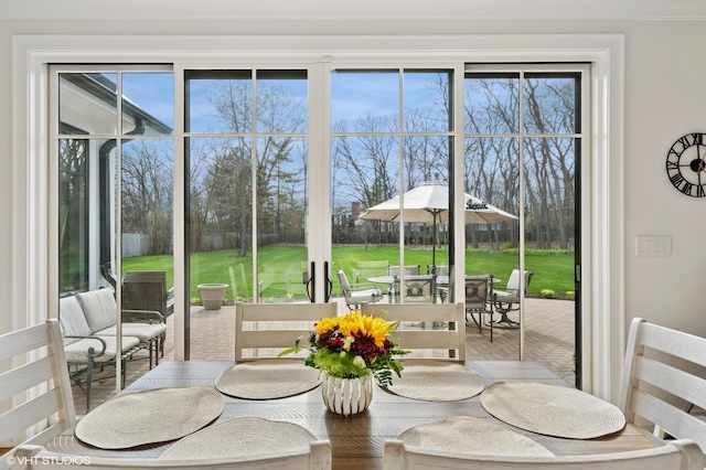 dining space with healthy amount of natural light and golf course view