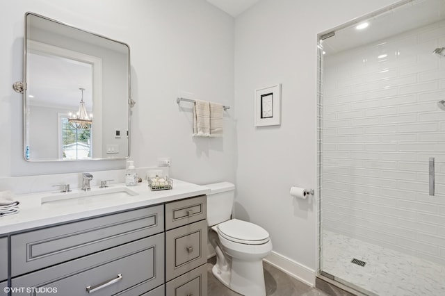 full bath with toilet, a shower stall, a chandelier, baseboards, and vanity