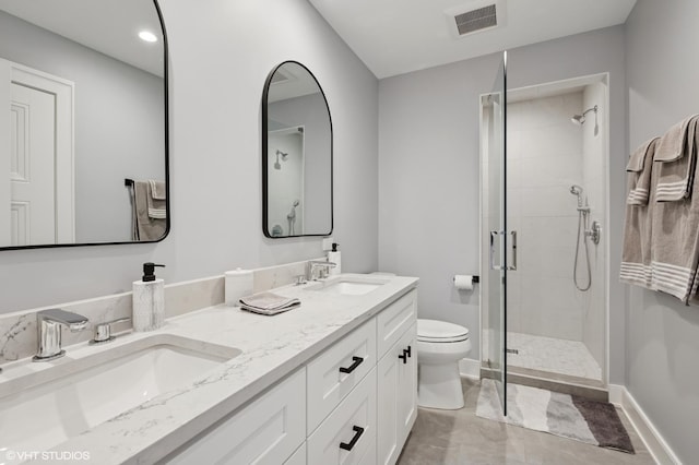 bathroom featuring a stall shower, toilet, baseboards, double vanity, and recessed lighting