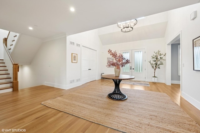 bonus room with lofted ceiling, stairway, light wood-style floors, baseboards, and recessed lighting