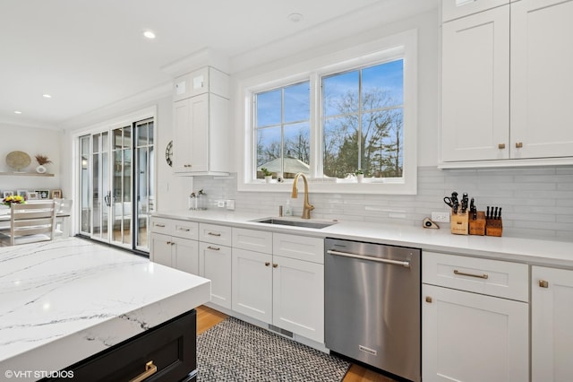kitchen with dishwasher, a sink, white cabinets, tasteful backsplash, and recessed lighting