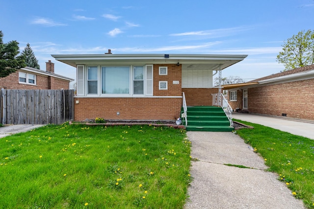 bungalow-style house with brick siding, fence, covered porch, and a front yard