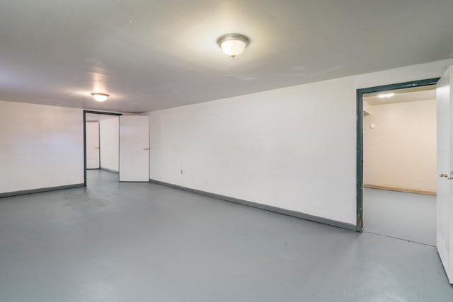interior space featuring baseboards and concrete flooring