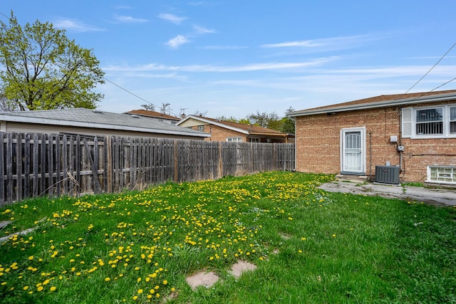 view of yard with a fenced backyard and cooling unit