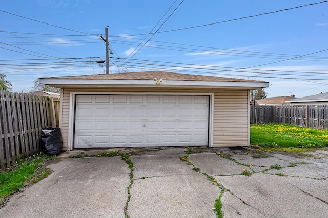 detached garage featuring fence
