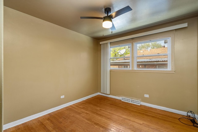 unfurnished room with light wood-style flooring, visible vents, baseboards, and ceiling fan