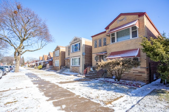 view of front facade featuring brick siding and a residential view