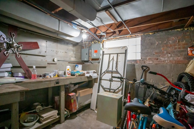 below grade area featuring electric panel and a workshop area