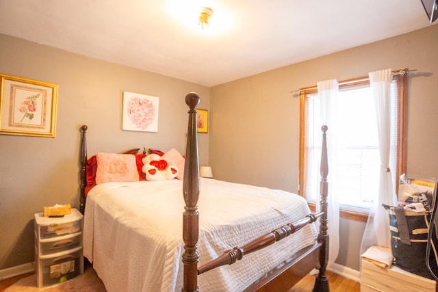 bedroom with wood finished floors and baseboards