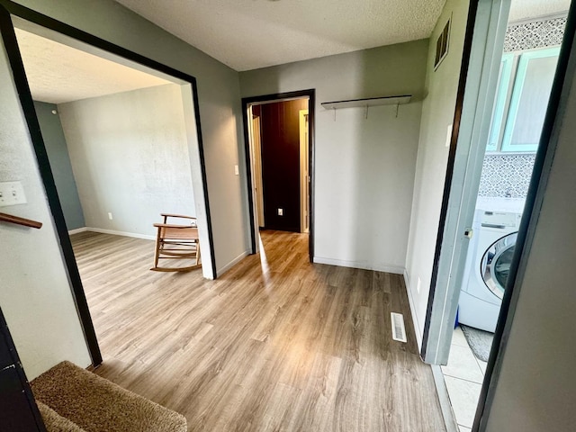 26812 US-150 Hwy, Leroy, IL 61752 - unfurnished bedroom featuring washer / clothes dryer, light wood finished floors, and baseboards