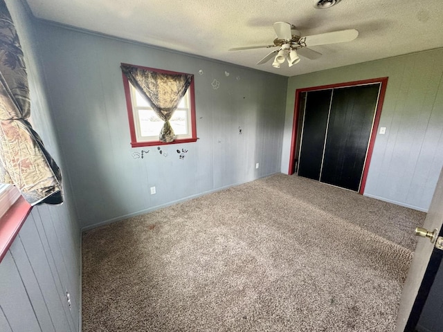 26812 US-150 Hwy, Leroy, IL 61752 - unfurnished bedroom featuring a textured ceiling, a closet, carpet, and ceiling fan